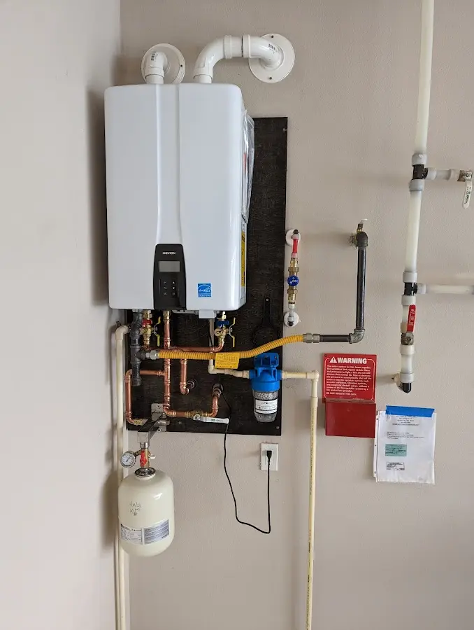 Professional plumber installing copper piping in a Lakewood Park home